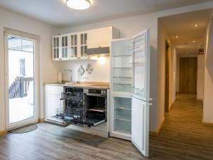 a kitchen with an open refrigerator in a room at Mill Pond Luxury Escape in Hemschlar +32 photos