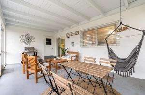 a room with a hammock and a table and chairs at Starfish Enterprise in Satellite Beach