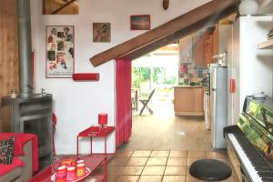 a living room with a red curtain and a fireplace at Maison charmante près d'Avignon avec terrasse in Avignon