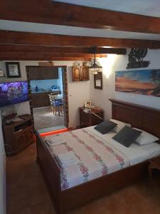 a bedroom with a bed and a living room at Family friendly house with a swimming pool Dazlina, Sibenik - 23303 in Tisno