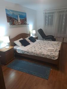 a bedroom with a bed and a chair in it at Family friendly house with a swimming pool Dazlina, Sibenik - 23303 in Tisno