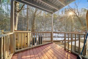 a screened porch with a view of the woods at Hidden Ranch in Sevierville