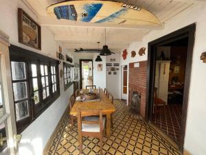 a dining room with a wooden table and chairs at Casa Alvear in Mar del Plata