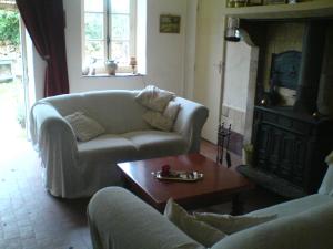 a living room with a couch and a coffee table at Les Champys in Saint-Péreuse