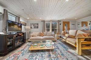 a living room with a couch and a tv at Hidden Ranch in Sevierville