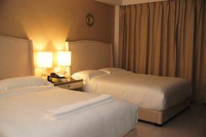 Postel nebo postele na pokoji v ubytování Hotel Morobe