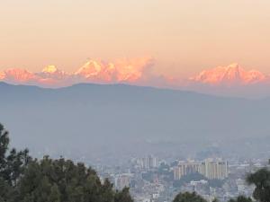 a view of a mountain range at sunset at Kathmandu Family Home in Kirtipur