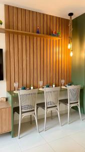 a dining room with a table and four chairs at Malia Muro Alto - Porto de Galinhas - Flat para 5 pessoas vista piscinas in Ipojuca