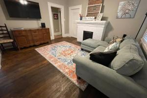 a living room with a couch and a fireplace at Sparkle City Cottage in Spartanburg