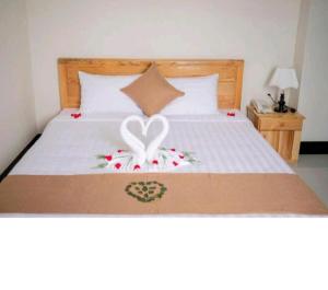 a bedroom with a bed with two hearts on it at Biển Nhớ Hotel & Coffee in Phan Thiet