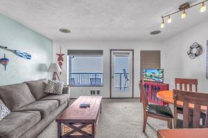 a living room with a couch and a table at Pacific Crest 306 in Newport