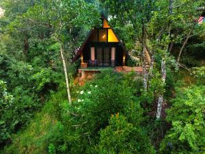 a small house in the middle of a forest at Water Side Cabin in Nallathaniya
