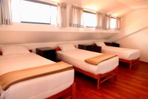 A bed or beds in a room at Anata Hotel