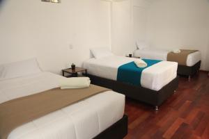 A bed or beds in a room at Anata Hotel