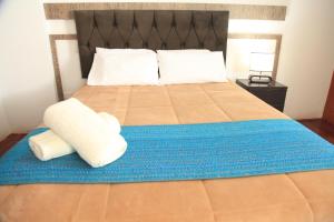 A bed or beds in a room at Anata Hotel