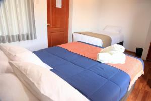 A bed or beds in a room at Anata Hotel