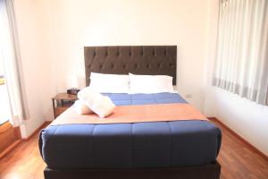 A bed or beds in a room at Anata Hotel