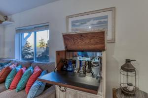 a living room with a couch and a sink at Rememberance in Depoe Bay