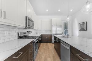 a large kitchen with white appliances and wooden cabinets at Villa #07 at Bloomington Country Club condo in St. George
