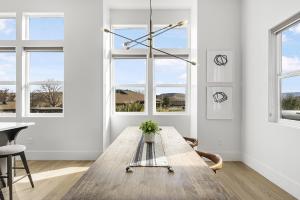 a dining room with a wooden table and windows at Villa #08 at Bloomington Country Club condo in St. George +40 photos