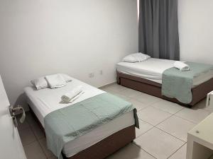 a room with two beds with towels on them at Apto Aquaville Resort in Aquiraz +78 photos