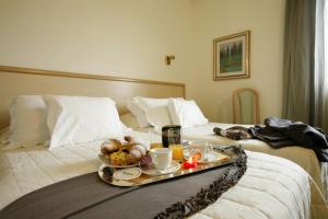 En eller flere senge i et værelse på Hotel Bassetto