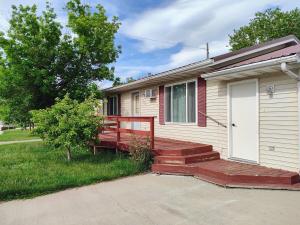 a house with a wooden deck next to a garage at Cozy town house in Wall! in Wall