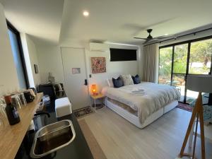 a bedroom with a bed and a desk with a television at Carnarvon Castle Eagle Bay in Dunsborough