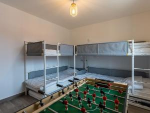 a room with two bunk beds and a pool table at Maison spacieuse 10p, proche plage, équipée, terrasse, Biscarrosse - FR-1-319-586 in Biscarrosse