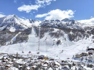une station de ski avec des montagnes enneigées en arrière-plan dans l'établissement Superbe duplex montagnard luxe pour 6 pers. à Montgenèvre - FR-1-445-214, à Montgenèvre