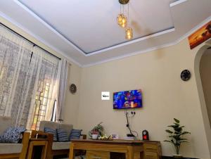 a living room with a coffered ceiling at Jegestal Serenity Homestay Camping and Tours in Lushoto