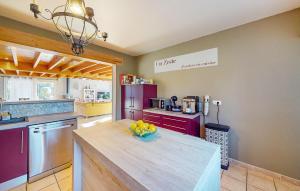 a kitchen with a table with a bowl of fruit on it at Lovely Home In Eyraud-Crempse-Maurens in Laveyssière