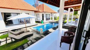 a swimming pool in the backyard of a house at UCU VILLAGE at ULUWATU JIMBARAN in Jimbaran
