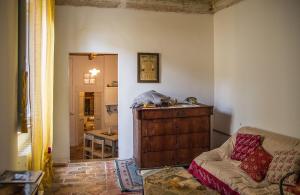 a living room with a couch and a table at La Neviera Nel Pozzo in Offida