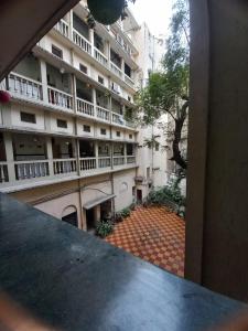 a view of a large apartment building from a window at HOTEL SREE DURGA in Kolkata
