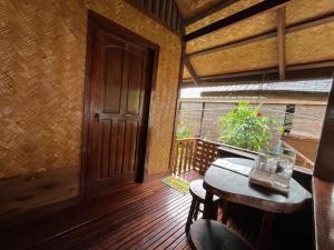 an empty room with a table and a door at MALAIKA RESORT in San Vicente