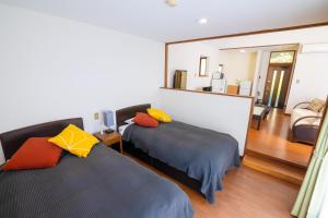Letto o letti in una camera di Le Nessa Akazawa