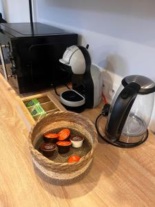 a basket of cupcakes on a table with a mixer at Écrin des nuages in Cognac