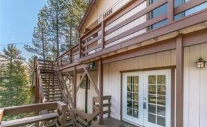 una casa con una escalera y un porche con una puerta en Sandalwood, en Pine Mountain Club