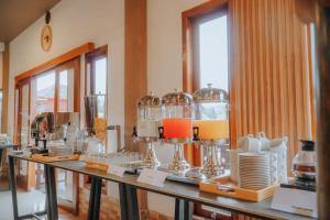 a room with a bunch of glass items on a table at Parama Bromo Hotel in Ngadisari +16 photos