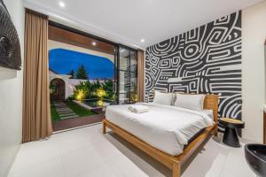 a bedroom with a bed and a large window at Alisa 4 - Brand New Villa with Breathtaking Garden Views - Expansive Pool - 4 Luxury Bedrooms in Seminyak