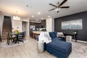 a living room with a blue couch and a dining room at Spacious Pet Friendly - 7 miles to Eagle Mountain Lake in Fort Worth
