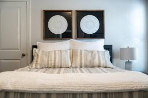a bedroom with a bed with two plates on the wall at Spacious Pet Friendly - 7 miles to Eagle Mountain Lake in Fort Worth