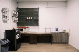 a kitchen with a counter and a black refrigerator at Cutie House in Tawau +10 photos