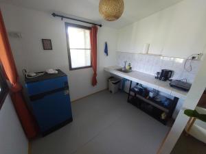 a small kitchen with a blue refrigerator and a counter at Sabai Homes 4 in Ko Phangan