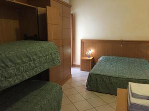 Postel nebo postele na pokoji v ubytování Hotel Vallefura