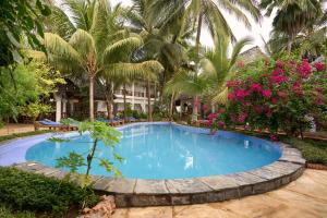 a swimming pool in front of a resort at African Bungalows in Nungwi