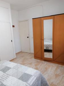 a bedroom with a bed and a large mirror at Mesana playa in Cartagena