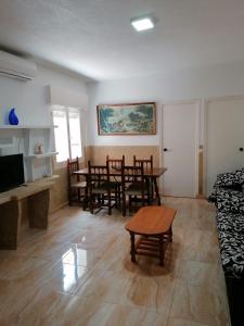 a living room with a table and chairs and a couch at Mesana playa in Cartagena