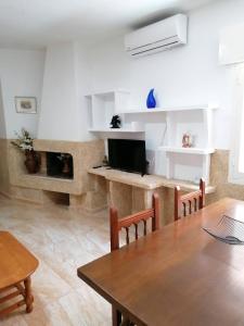 a living room with a table and a fireplace at Mesana playa in Cartagena